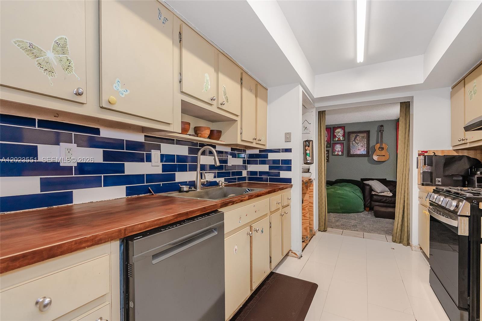 11482 Southwest 109th Road, Unit 29A Miami, FL 33176 - Photo 9 of 28 a kitchen with stainless steel appliances granite countertop a sink and cabinets