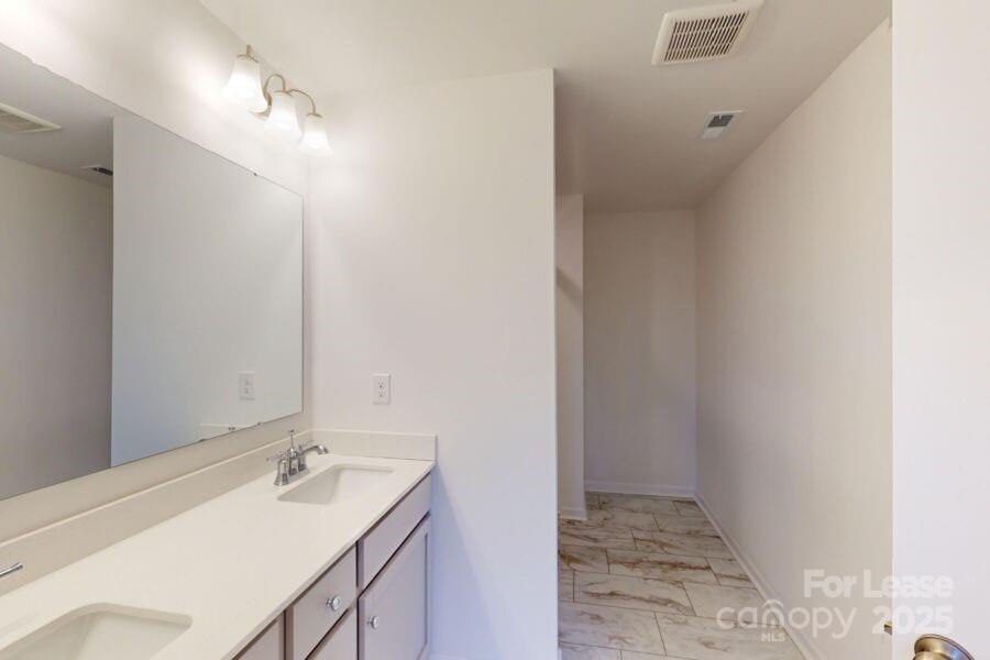 3519 Secrest Landing Monroe, NC 28110 - Photo 16 of 25 a bathroom with a sink and a mirror