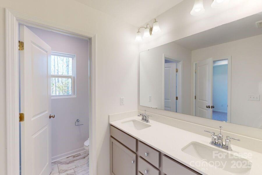 3519 Secrest Landing Monroe, NC 28110 - Photo 17 of 25 a bathroom with a sink double vanity and a mirror