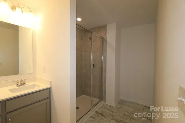 a bathroom with a shower and a sink