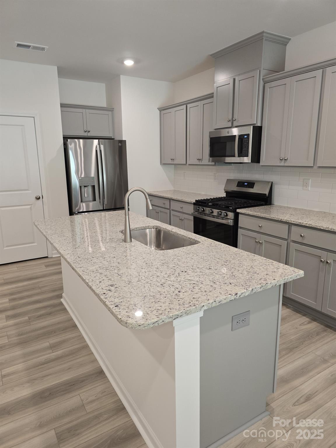 3519 Secrest Landing Monroe, NC 28110 - Photo 5 of 25 a kitchen with stainless steel appliances granite countertop a sink stove microwave and cabinets