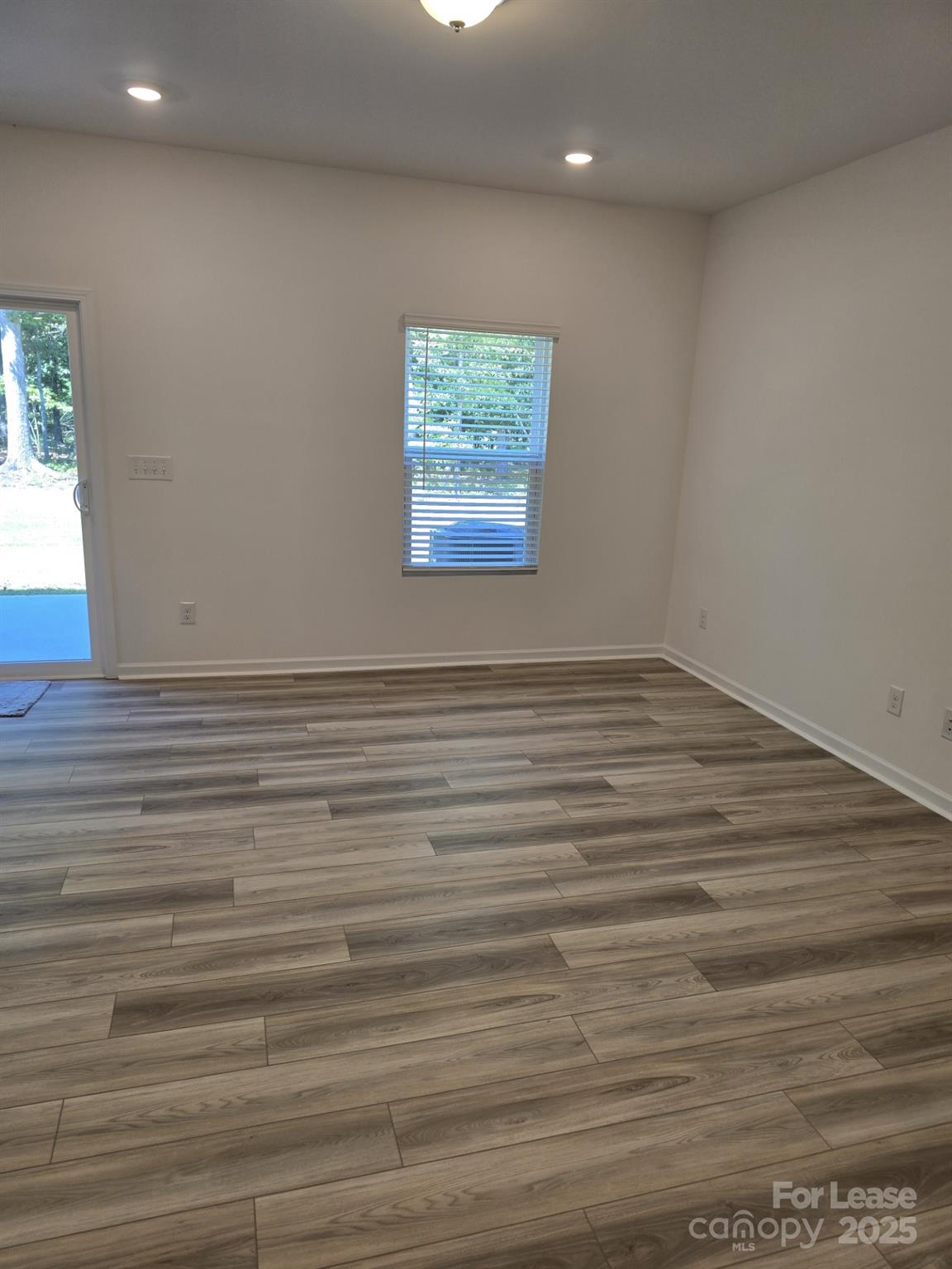 3519 Secrest Landing Monroe, NC 28110 - Photo 9 of 25 a view of an empty room with window and wooden floor