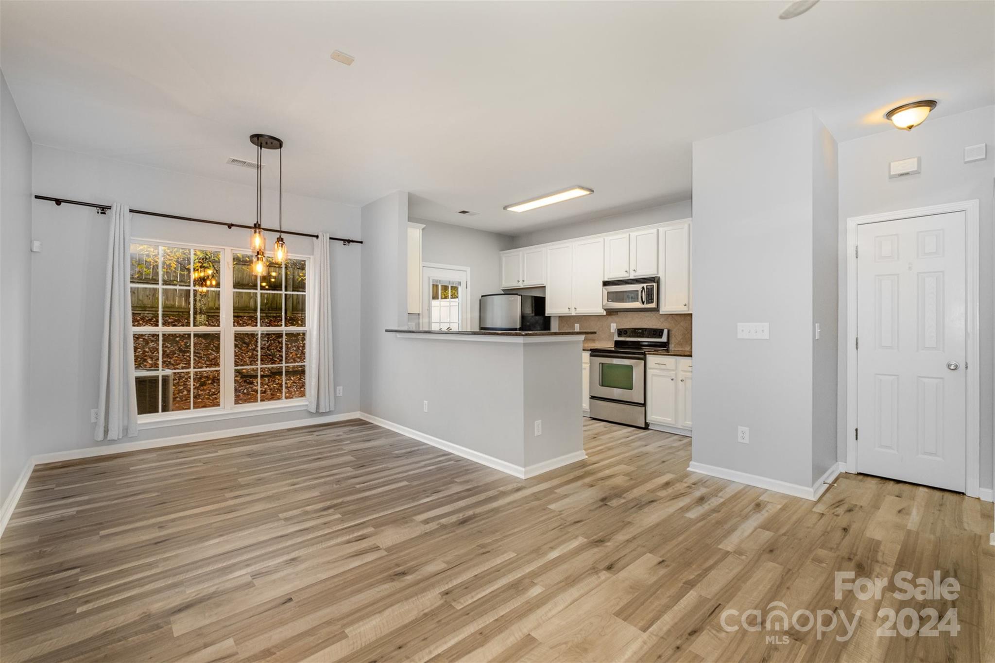 2111 Midnight Blue Lane Fort Mill, SC 29708 - Photo 8 of 27 a view of kitchen with wooden floor electronic appliances and window