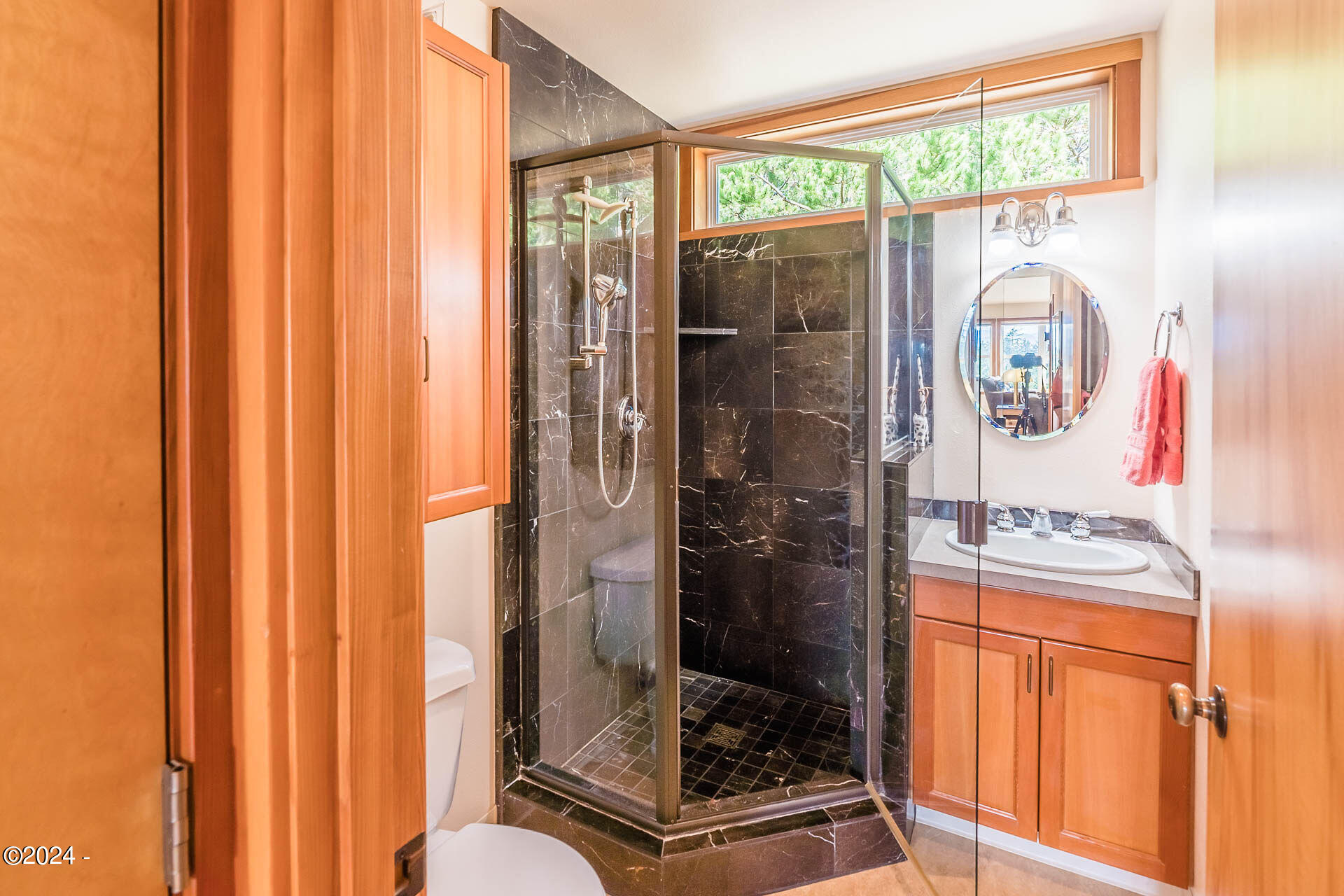 6855 Nestucca Ridge Road Pacific City, OR 97135 - Photo 27 of 44 a bathroom with a glass shower door and a window