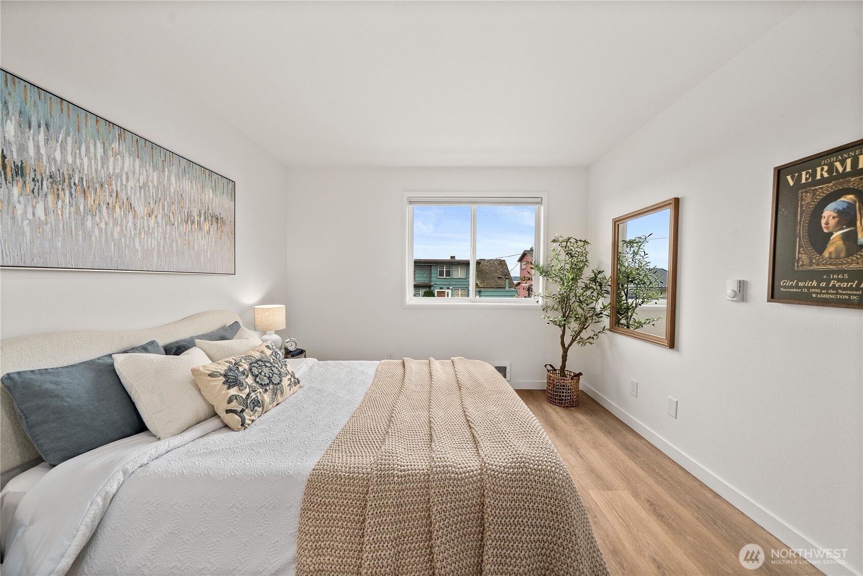 4226 Beach Drive Southwest, Unit 102 Seattle, WA 98116 - Photo 14 of 20 a bed room with a bed and a painting on the wall