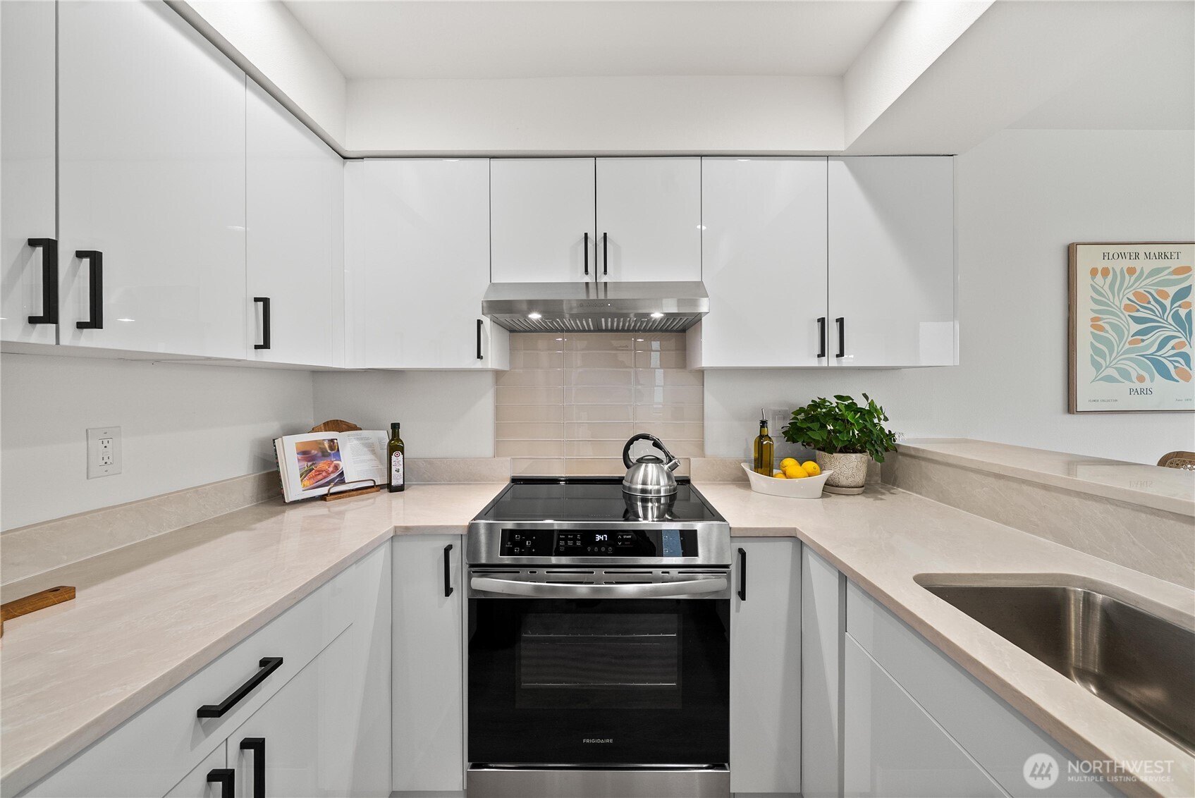 4226 Beach Drive Southwest, Unit 102 Seattle, WA 98116 - Photo 9 of 20 a kitchen with granite countertop a stove and a sink