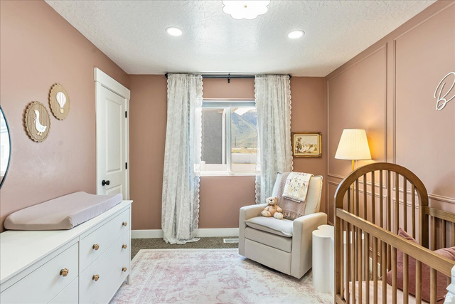 3916 South Sage Wood Avenue Mapleton, UT 84664 - Photo 14 of 33 Room featuring recessed lighting, a window with mountain scenery, and carpet flooring