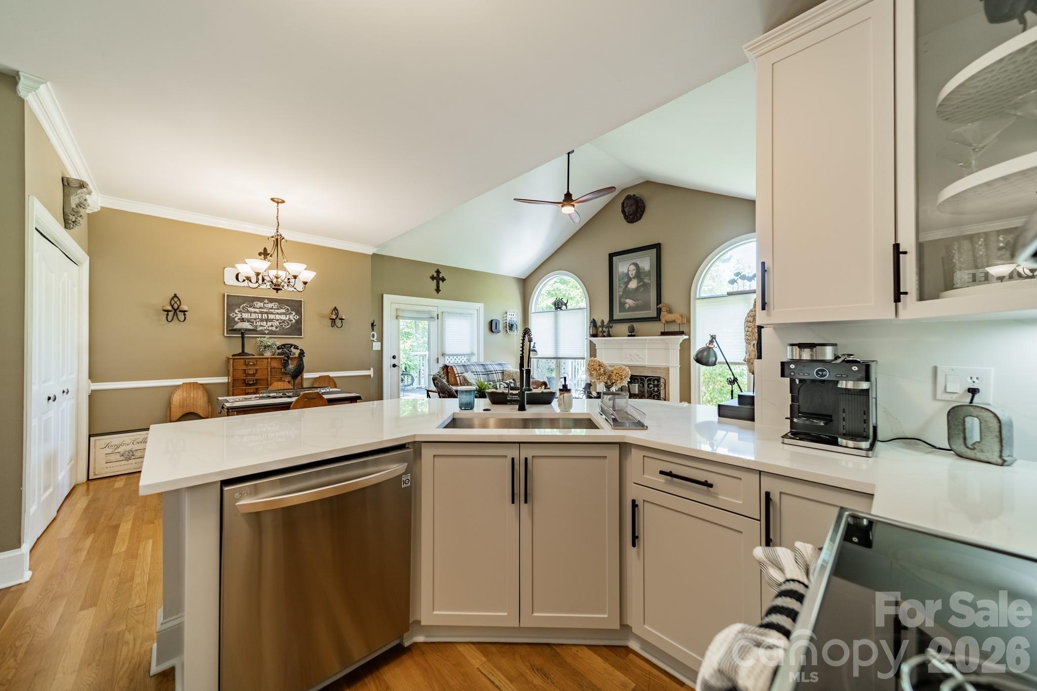 11043 Seven Coves Drive Tega Cay, SC 29708 - Photo 26 of 45 a kitchen with a sink a stove cabinets and a dining table