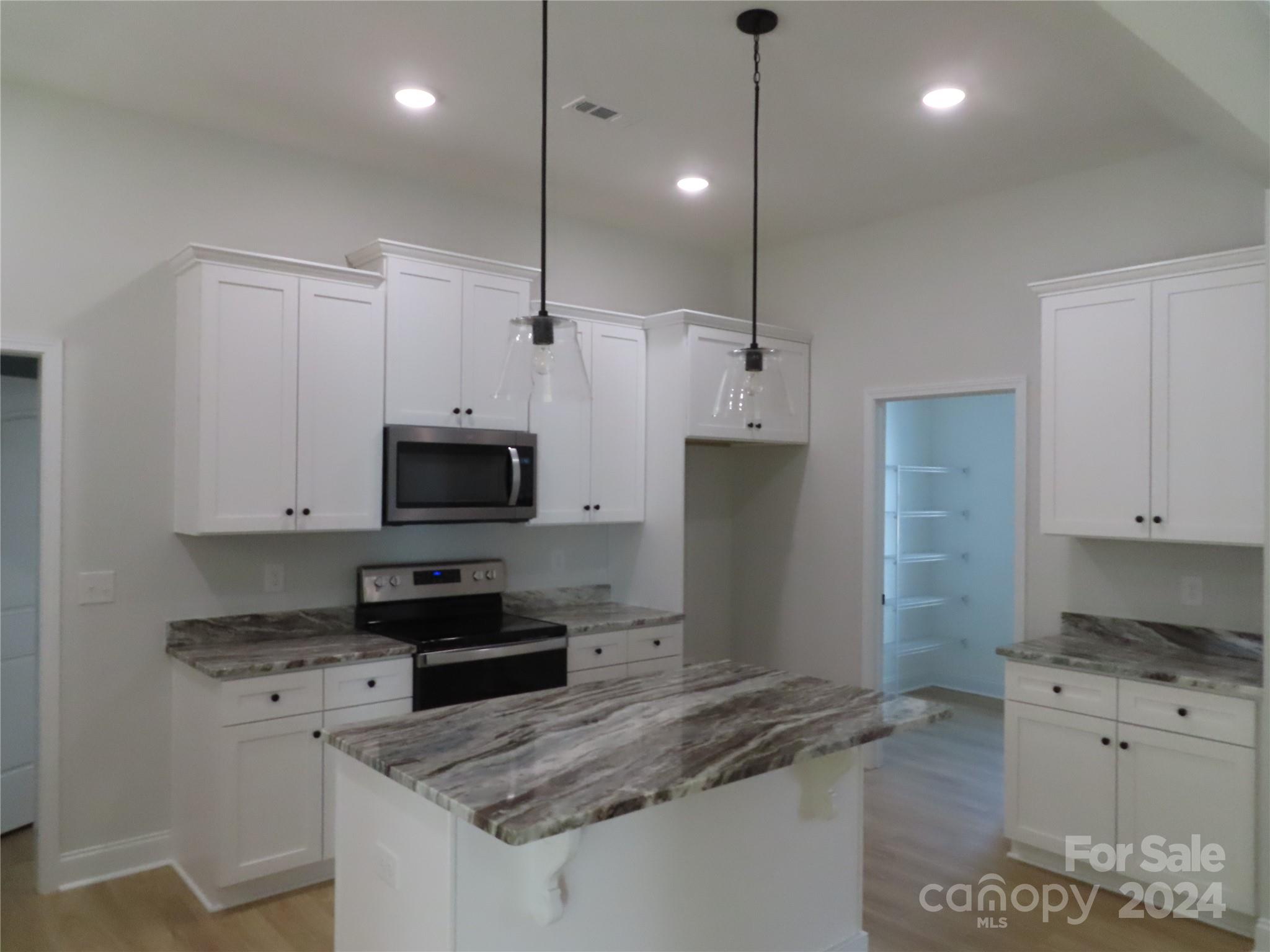 2225 Cedar Road, Unit 1 York, SC 29745 - Photo 29 of 31 a kitchen with granite countertop a sink a counter top space stainless steel appliances and cabinets