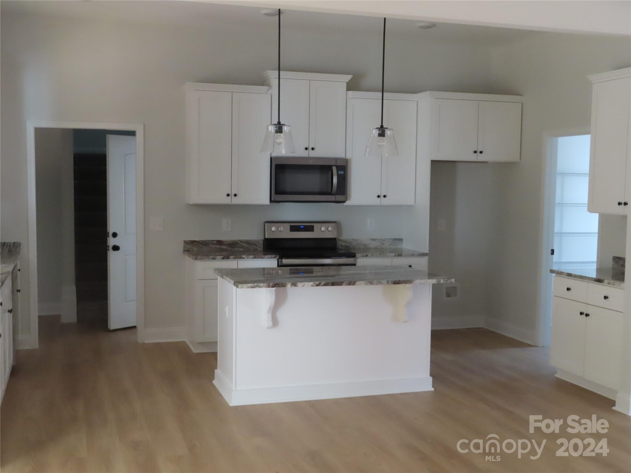 2225 Cedar Road, Unit 1 York, SC 29745 - Photo 9 of 31 a kitchen with stainless steel appliances granite countertop a stove a refrigerator a oven and white cabinets