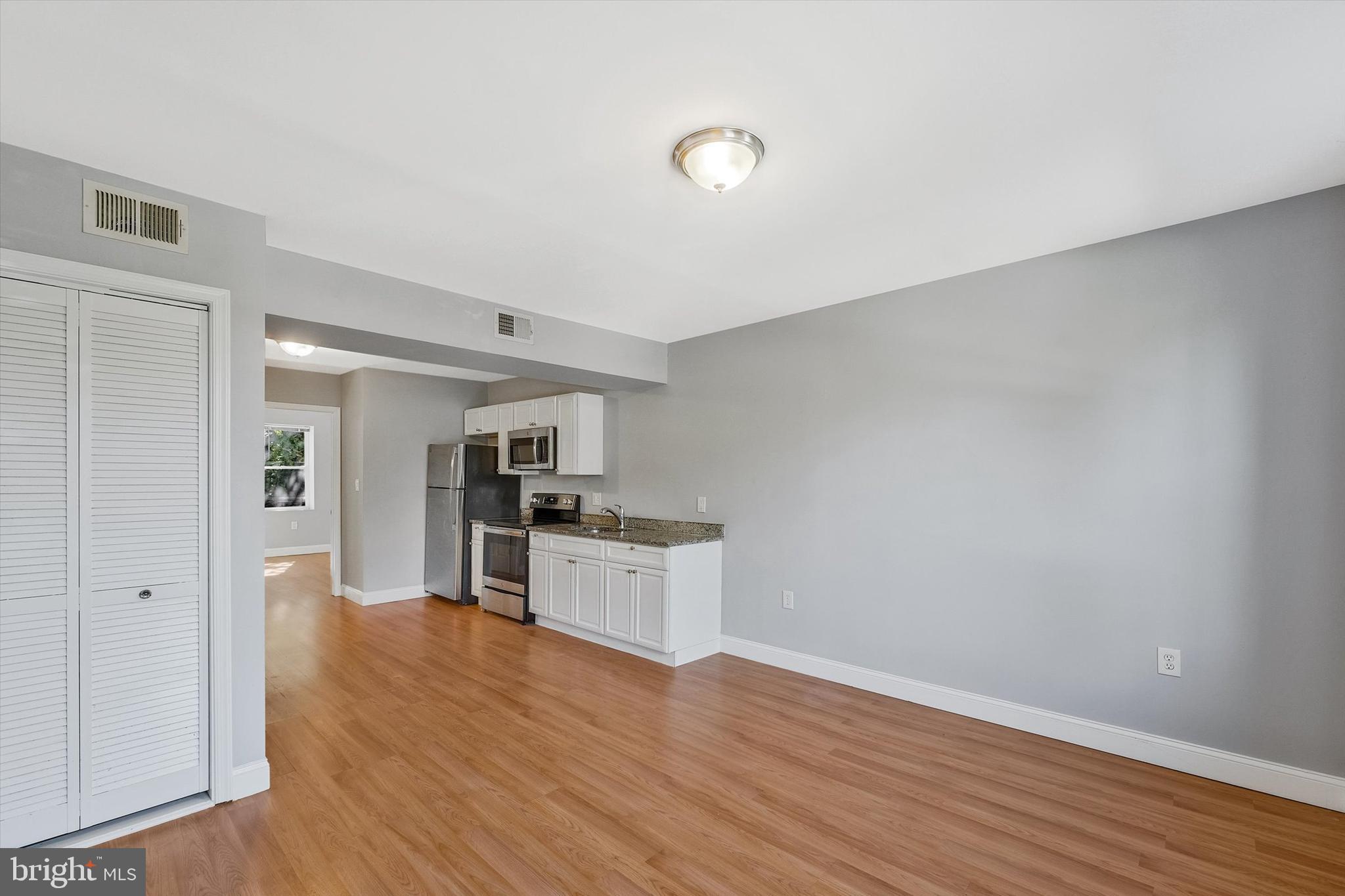 433 Atlantic Street Southeast Washington, DC 20032 - Photo 3 of 15 a view of a kitchen with a sink stove cabinets and empty room