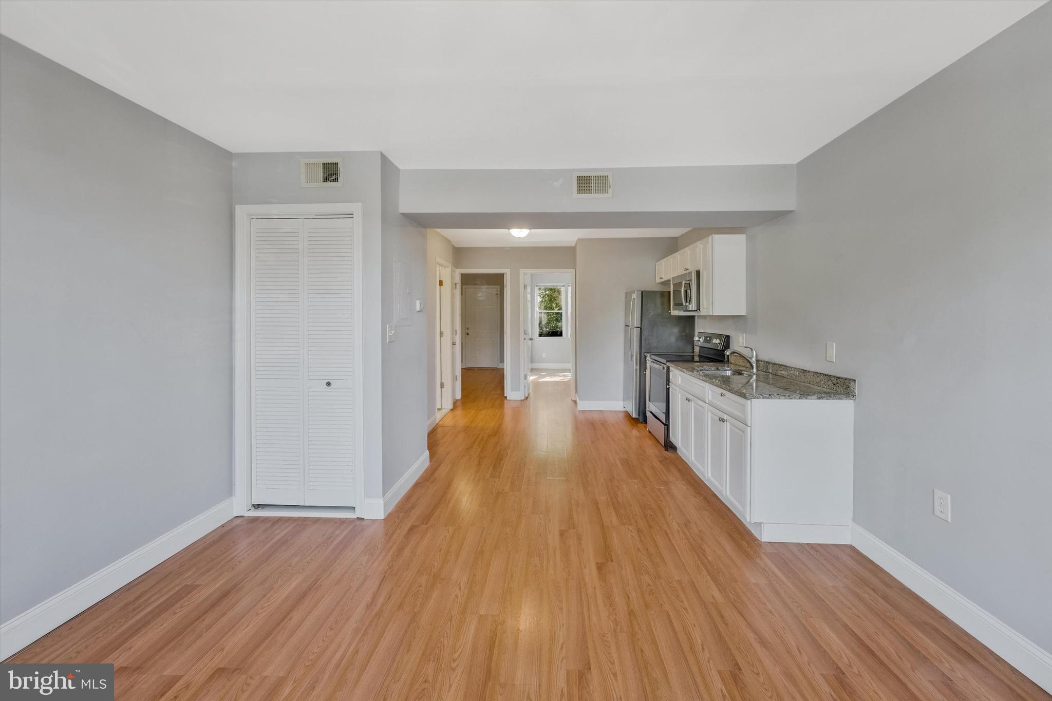 433 Atlantic Street Southeast Washington, DC 20032 - Photo 6 of 15 a view of a kitchen with wooden floor and electronic appliances