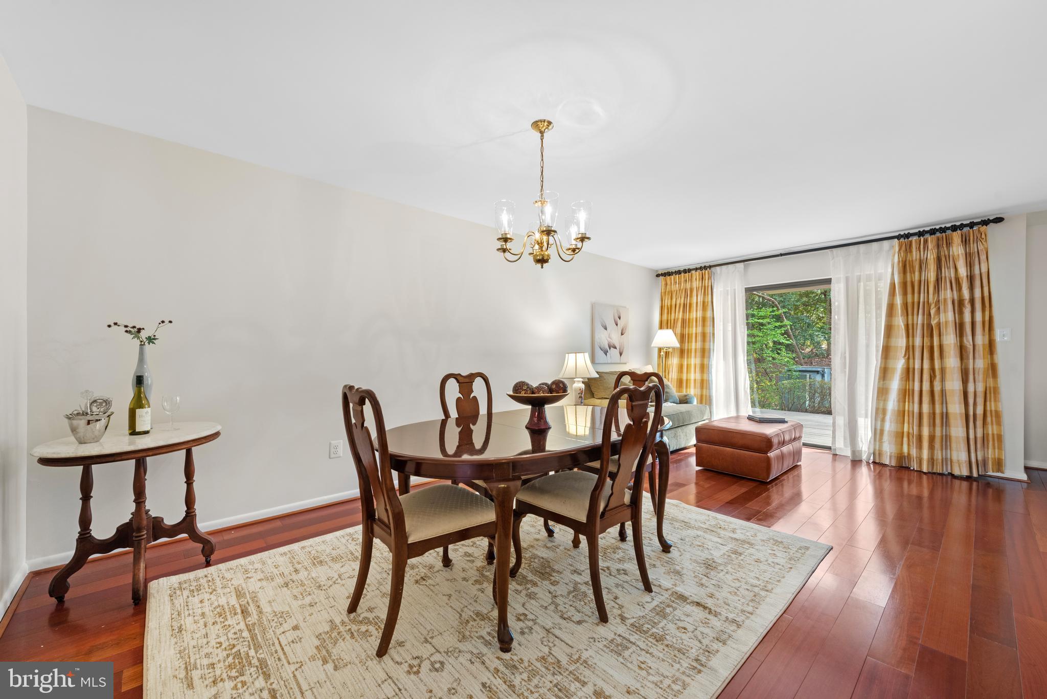 11711 Newbridge Court Reston, VA 20191 - Photo 14 of 37 a dining room with furniture a chandelier and wooden floor