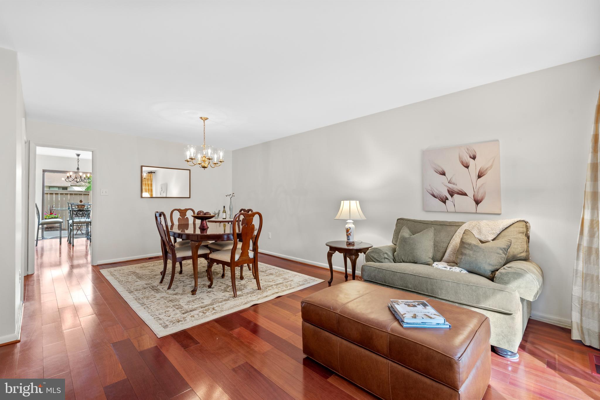 11711 Newbridge Court Reston, VA 20191 - Photo 15 of 37 a living room with furniture dining table and wooden floor