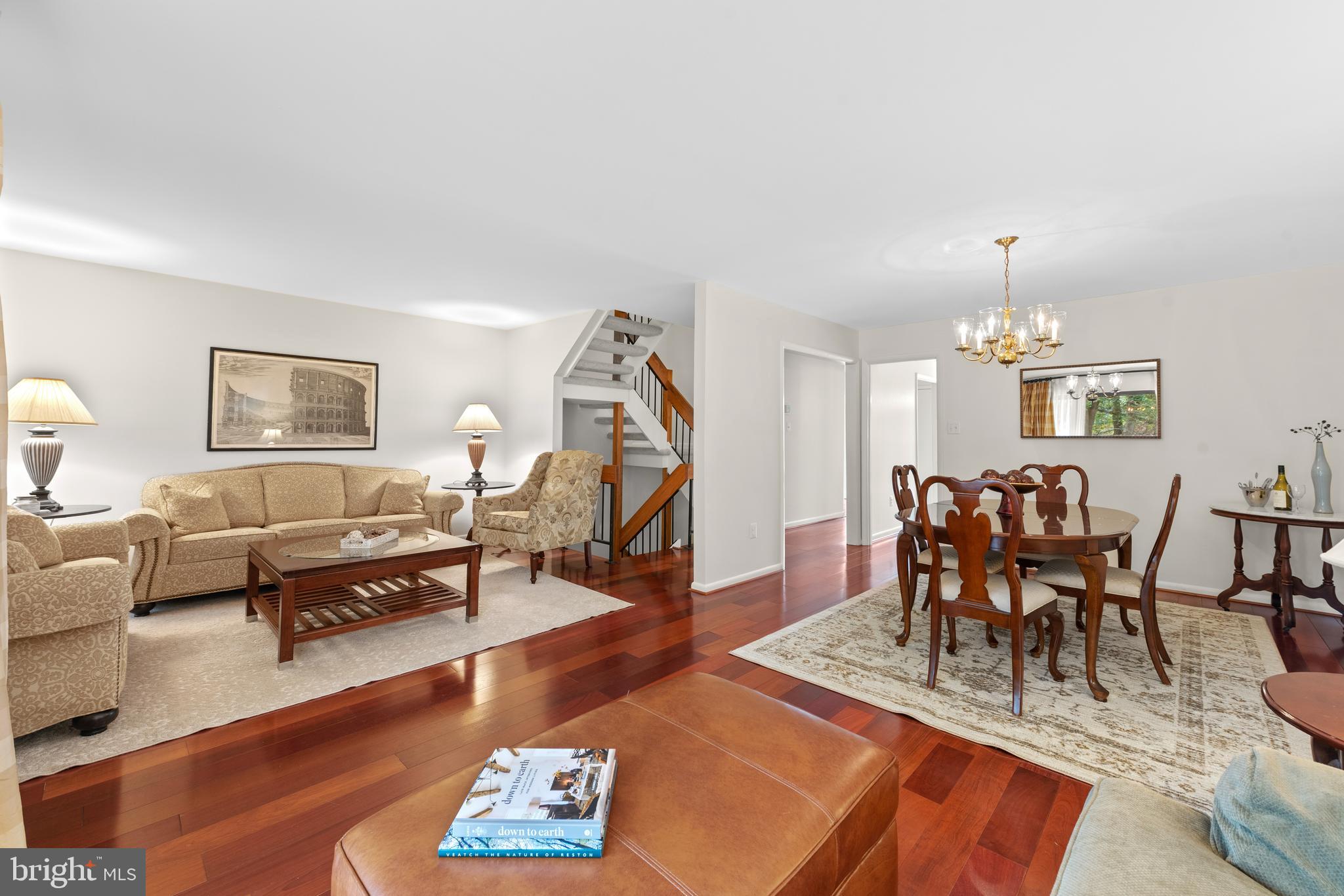 11711 Newbridge Court Reston, VA 20191 - Photo 16 of 37 a living room with furniture a rug and a chandelier