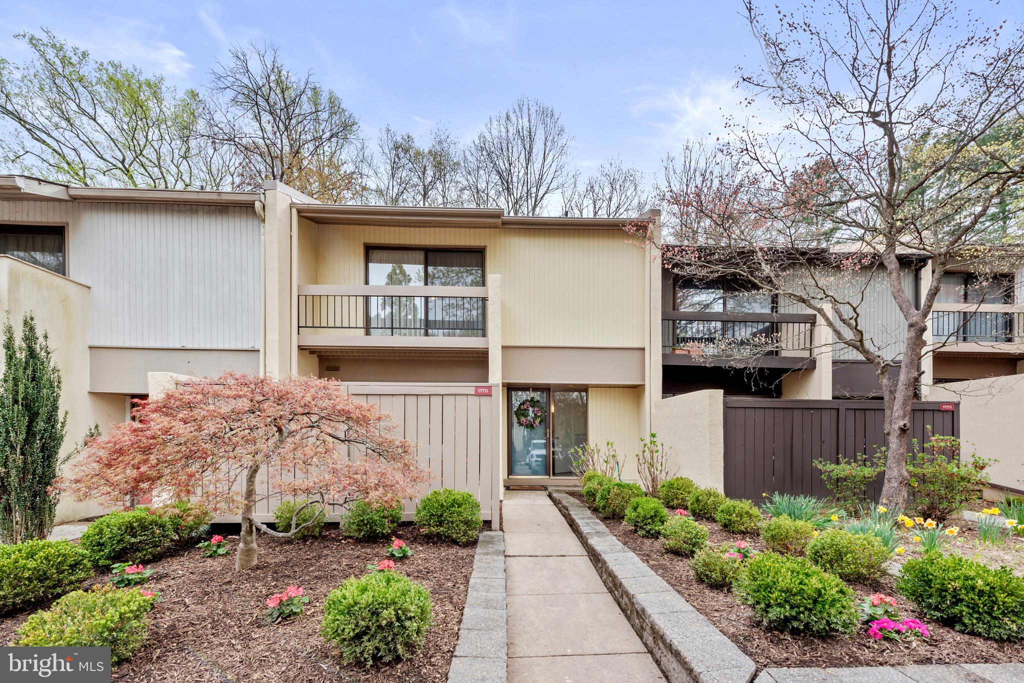 11711 Newbridge Court Reston, VA 20191 - Photo 2 of 37 a front view of a house with garden