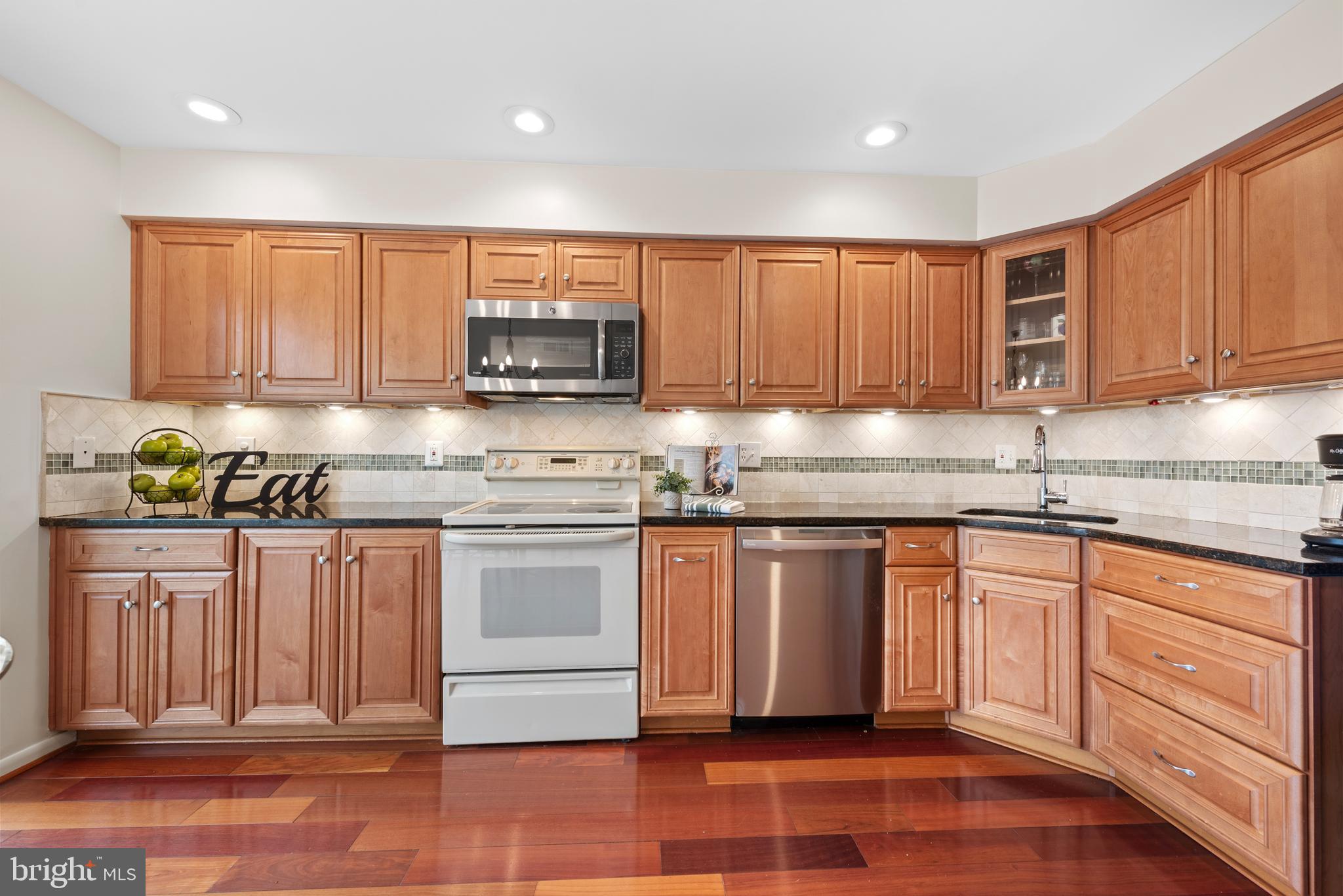 11711 Newbridge Court Reston, VA 20191 - Photo 7 of 37 a kitchen with granite countertop a sink cabinets and stainless steel appliances