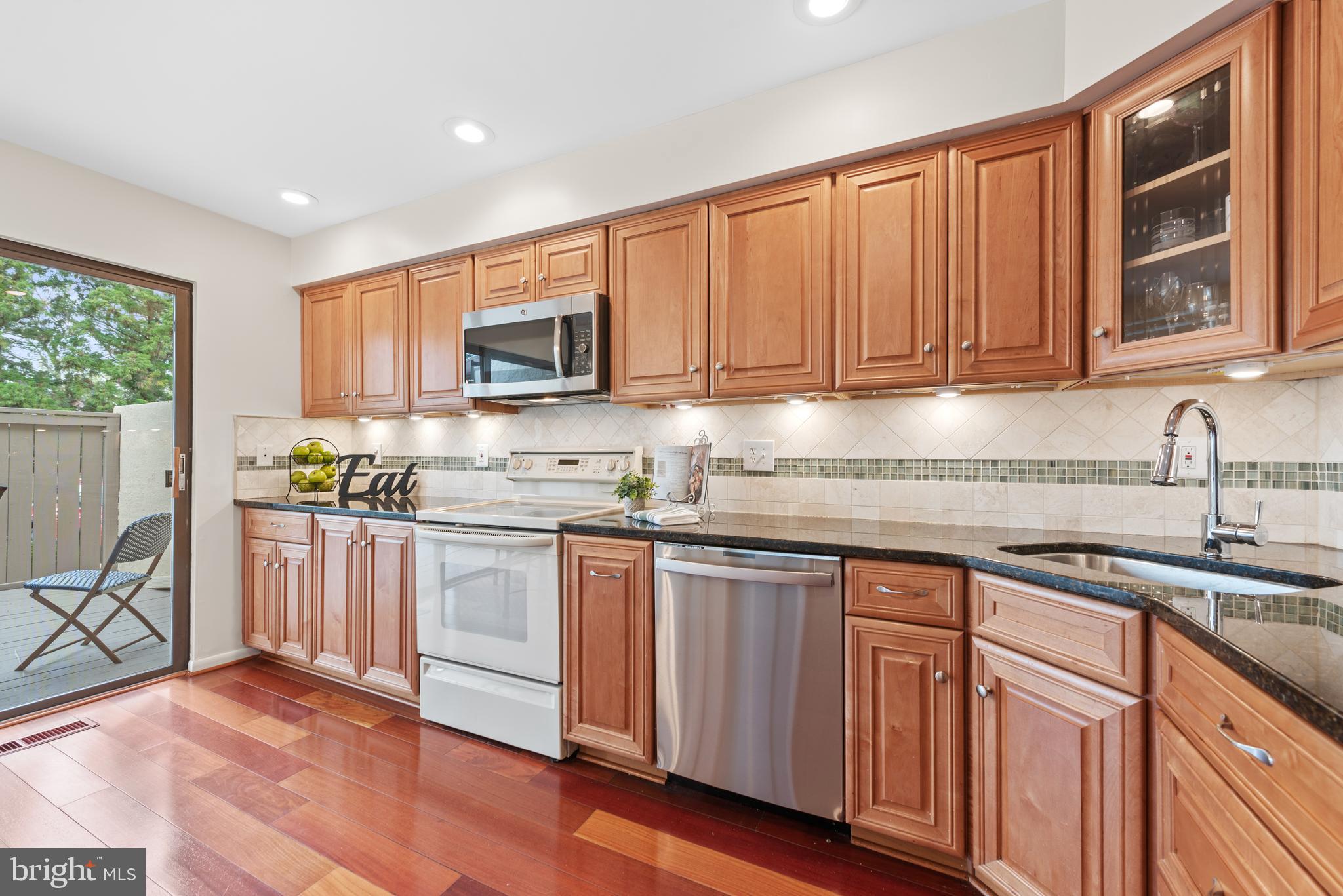 11711 Newbridge Court Reston, VA 20191 - Photo 8 of 37 a kitchen with stainless steel appliances granite countertop a stove a sink and a microwave