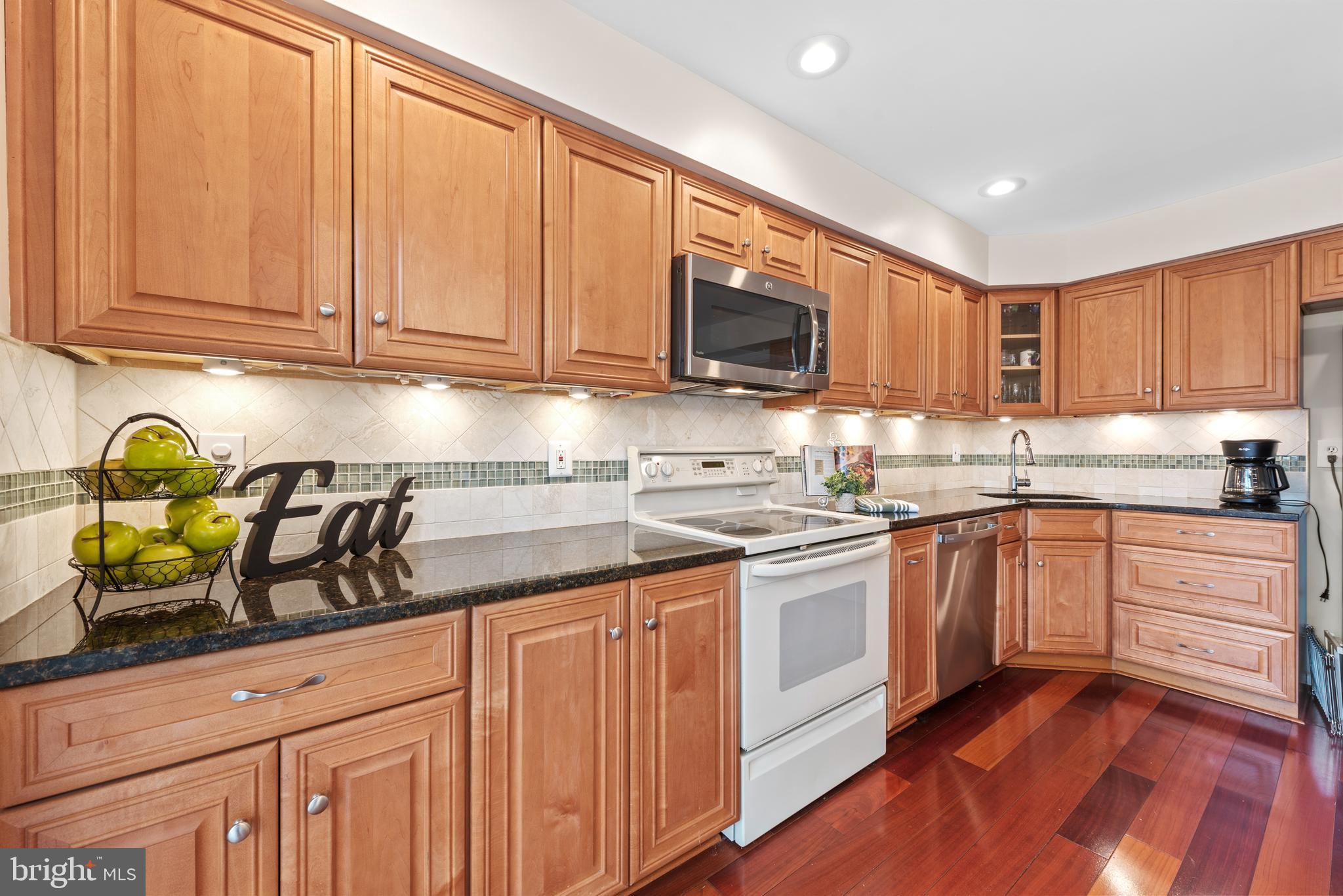 11711 Newbridge Court Reston, VA 20191 - Photo 9 of 37 a kitchen with granite countertop a sink stainless steel appliances and cabinets