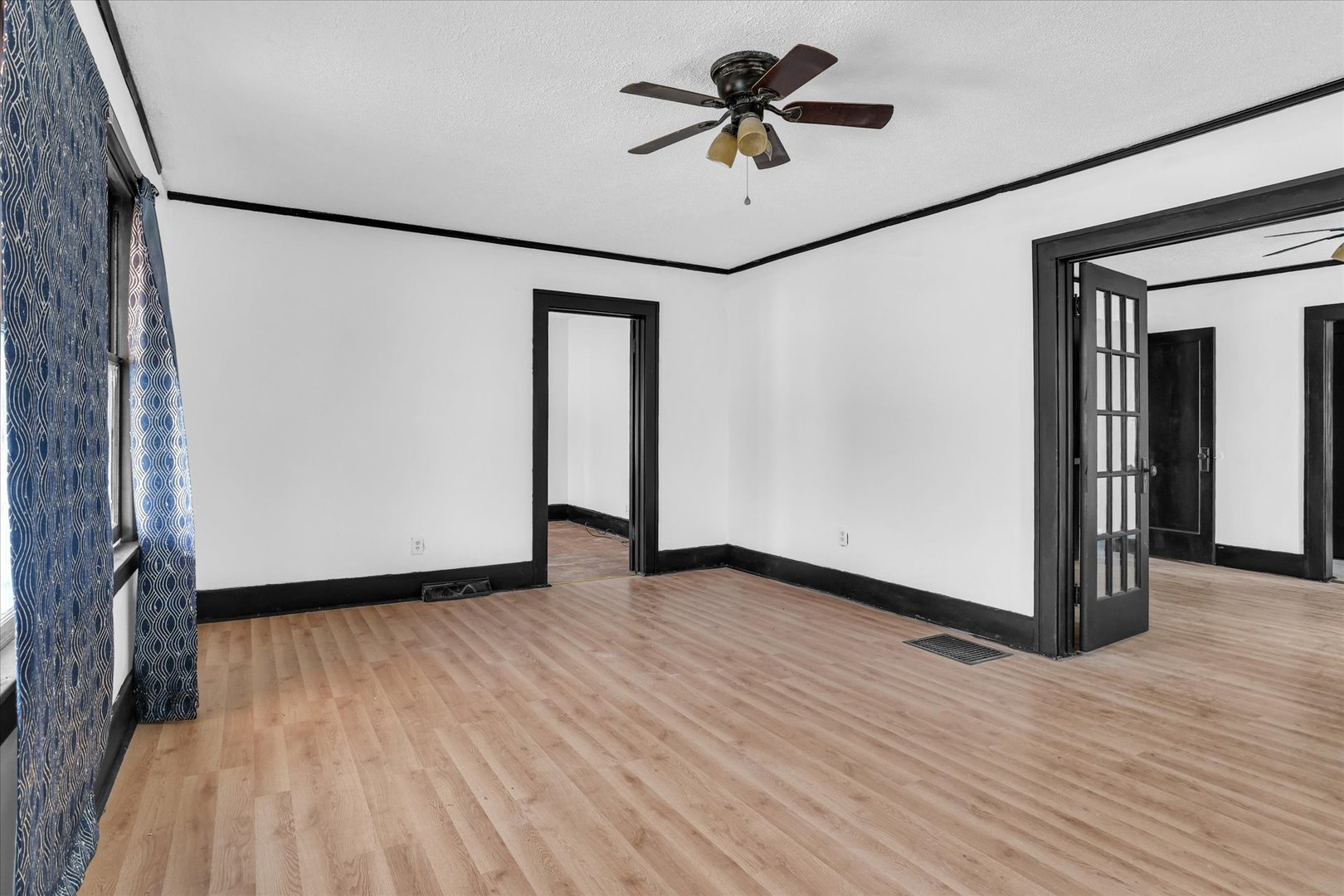 1504 North Monroe Street Decatur, IL 62526 - Photo 7 of 36 a view of empty room with wooden floor and fan
