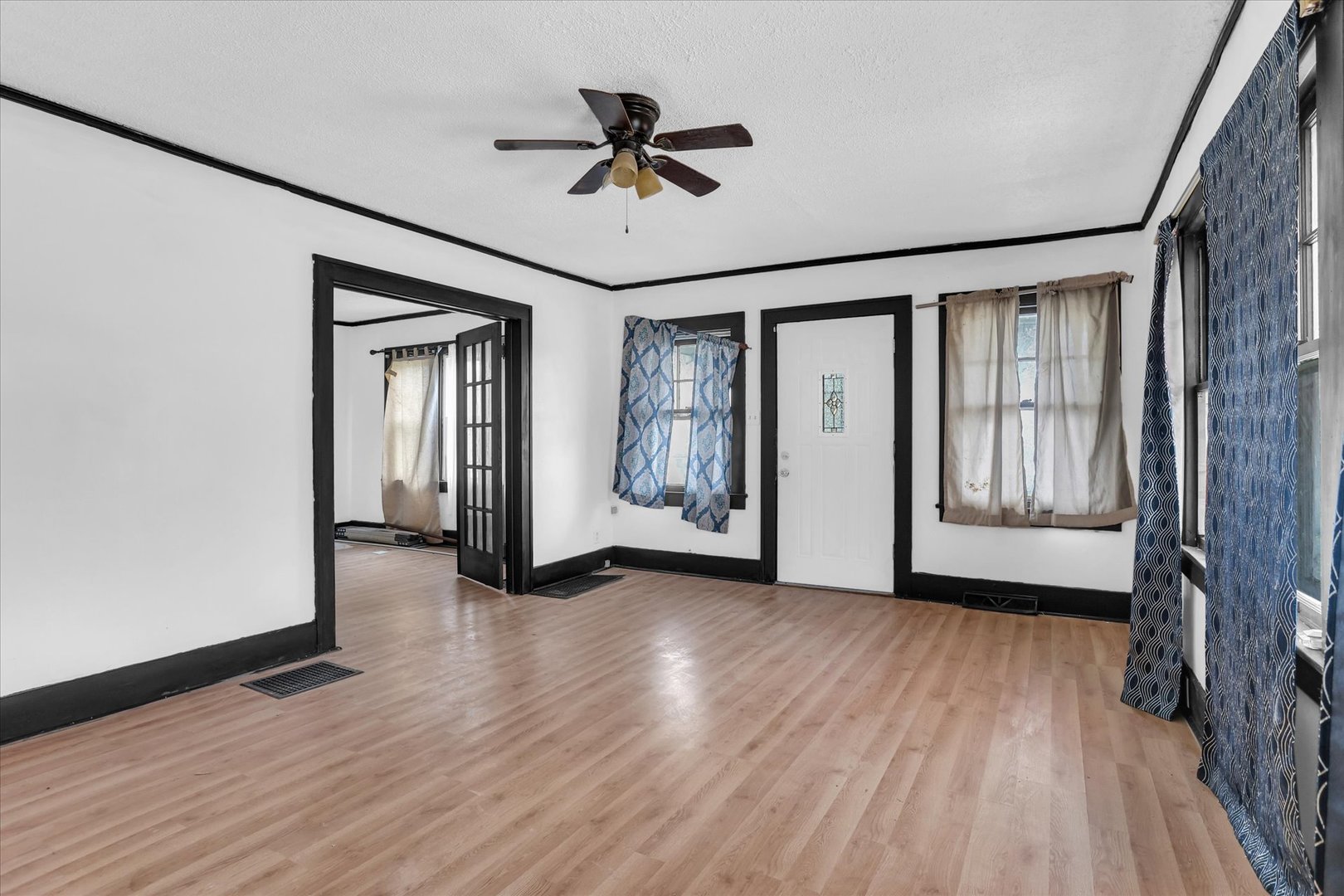 1504 North Monroe Street Decatur, IL 62526 - Photo 8 of 36 a view of an empty room with a window and wooden floor