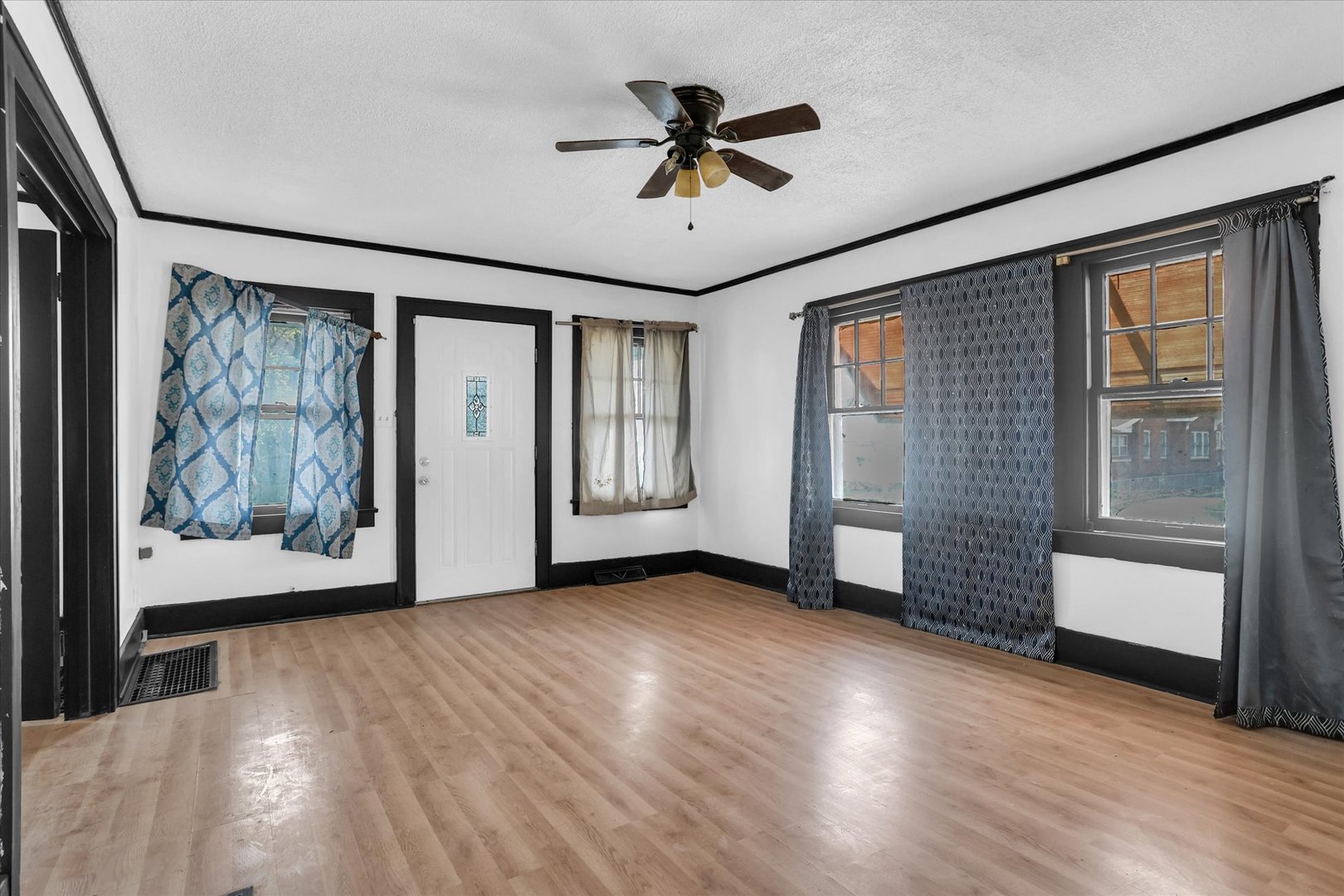 1504 North Monroe Street Decatur, IL 62526 - Photo 9 of 36 a view of an empty room with a window and wooden floor