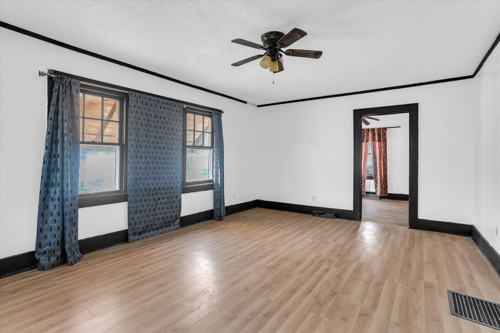 1504 North Monroe Street Decatur, IL 62526 - Photo 10 of 36 an empty room with wooden floor and windows