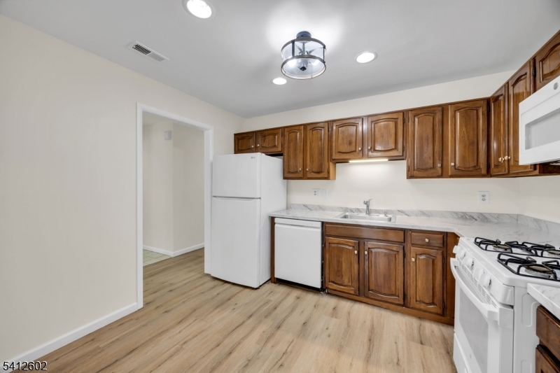 113 Heather Court Edison, NJ 08820 - Photo 11 of 30 a kitchen with a sink cabinets stainless steel appliances and a window
