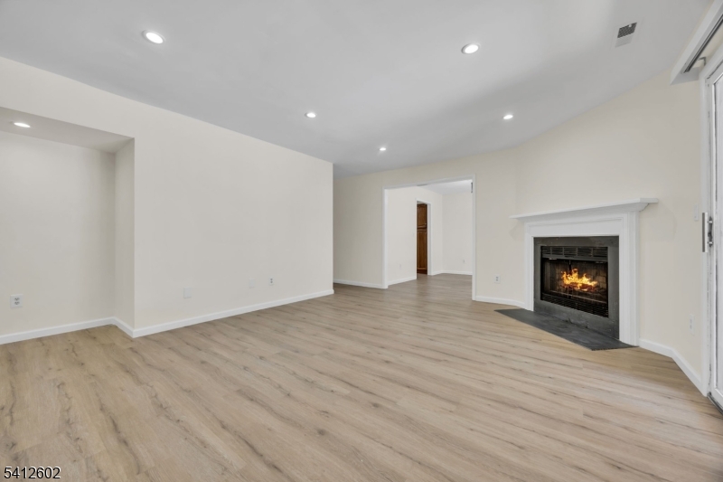 113 Heather Court Edison, NJ 08820 - Photo 3 of 30 a view of an empty room with wooden floor fireplace and a window