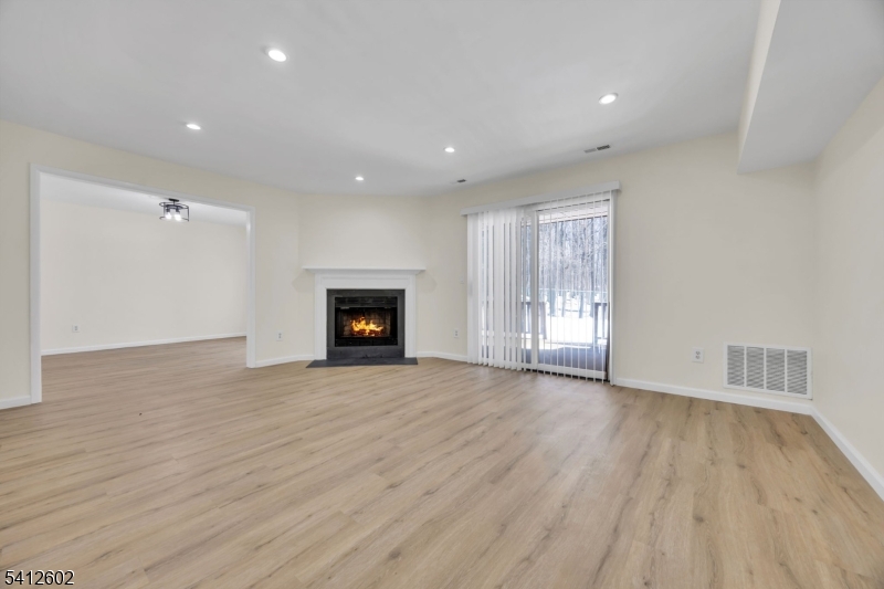 113 Heather Court Edison, NJ 08820 - Photo 5 of 30 a view of an empty room with wooden floor fireplace and a window