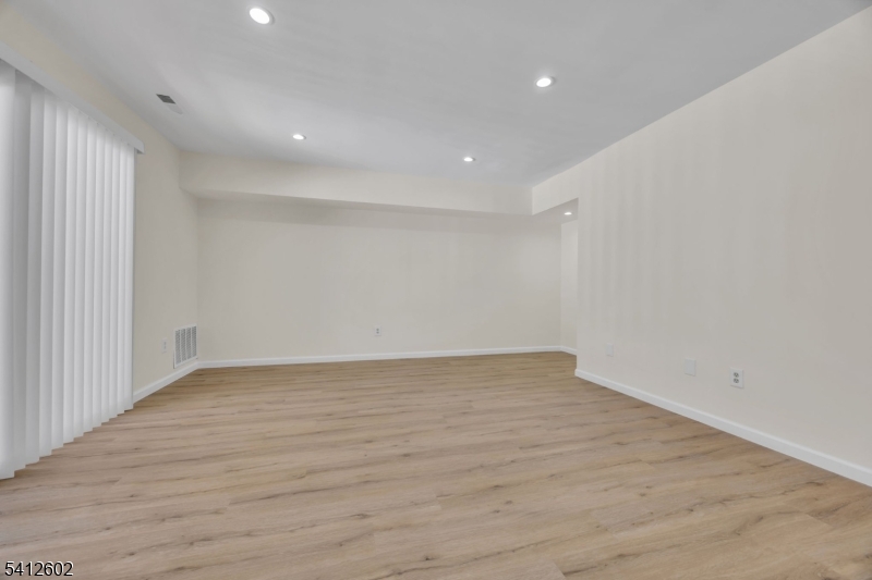 113 Heather Court Edison, NJ 08820 - Photo 6 of 30 an empty room with wooden floor and windows