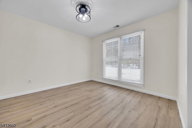 113 Heather Court Edison, NJ 08820 - Photo 8 of 30 an empty room with wooden floor and windows