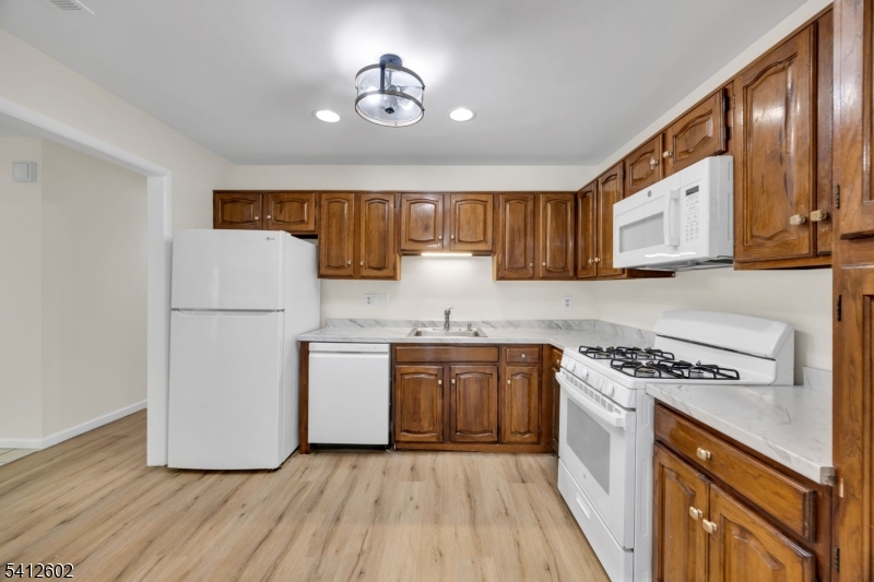 113 Heather Court Edison, NJ 08820 - Photo 10 of 30 a kitchen with stainless steel appliances granite countertop a stove a sink dishwasher and a refrigerator with wooden floor