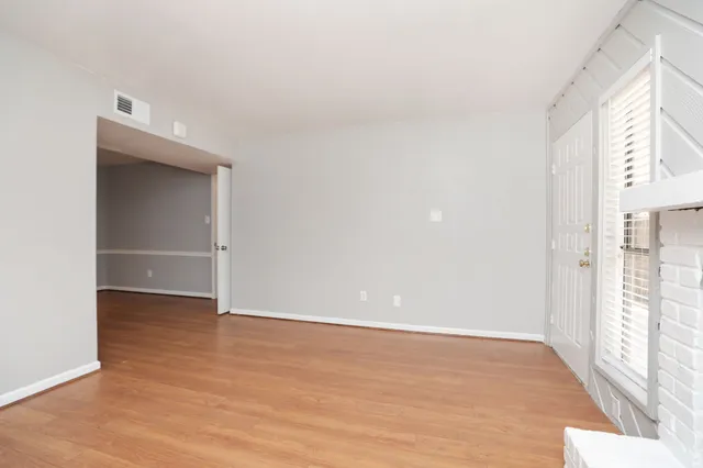a view of a room with wooden floor
