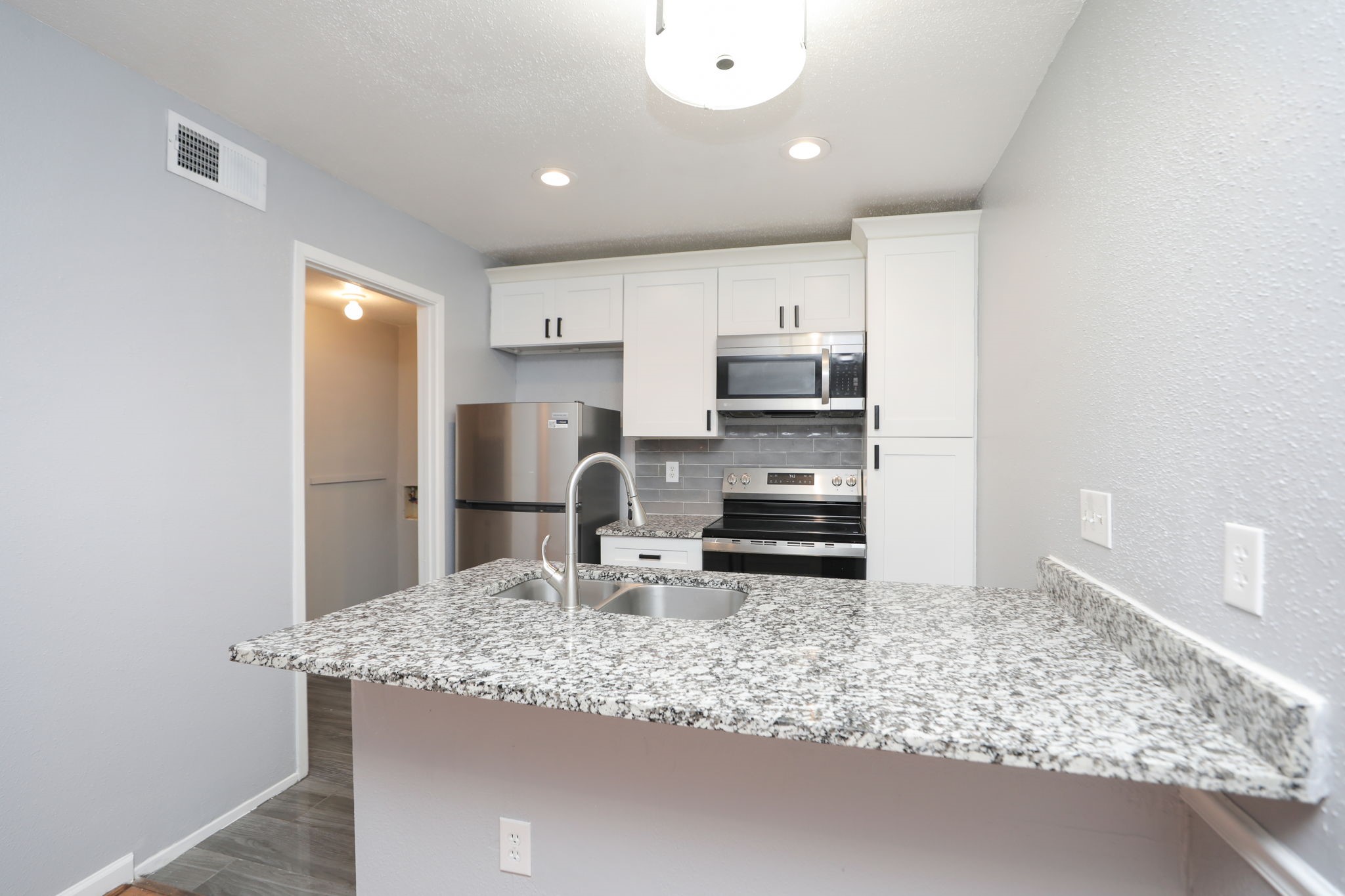 2100 Wilcrest Drive, Unit 127 Houston, TX 77077 - Photo 17 of 38 a kitchen with stainless steel appliances granite countertop a sink stove and refrigerator