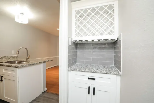 a kitchen with stainless steel appliances granite countertop a sink a stove and a refrigerator