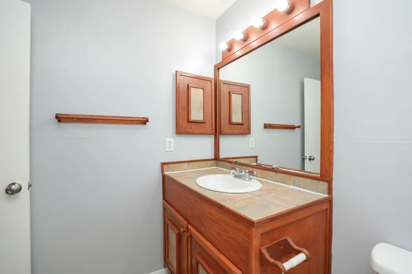 a bathroom with a sink toilet and mirror