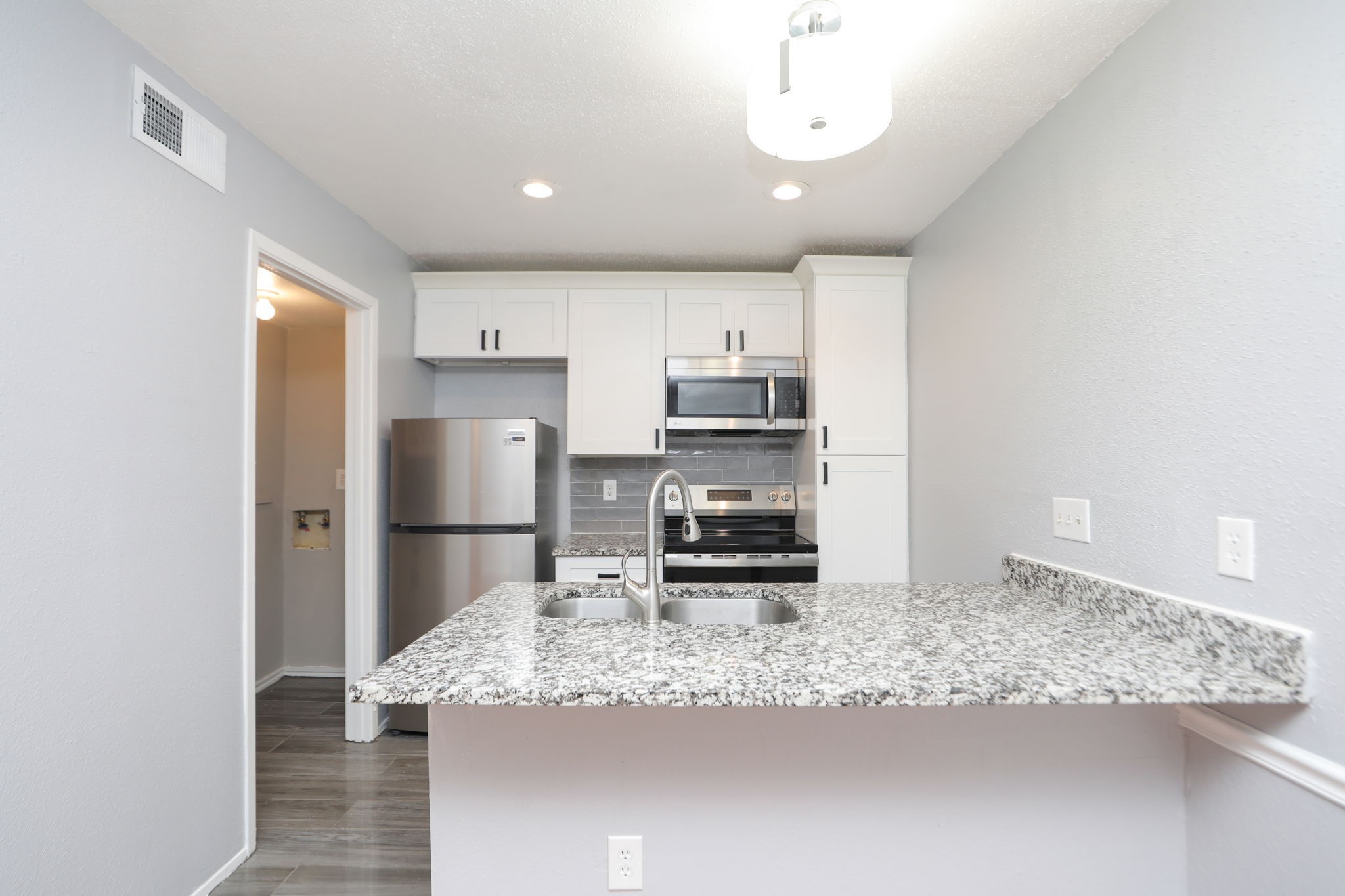 2100 Wilcrest Drive, Unit 127 Houston, TX 77077 - Photo 24 of 38 a kitchen with stainless steel appliances granite countertop a sink a stove and a refrigerator