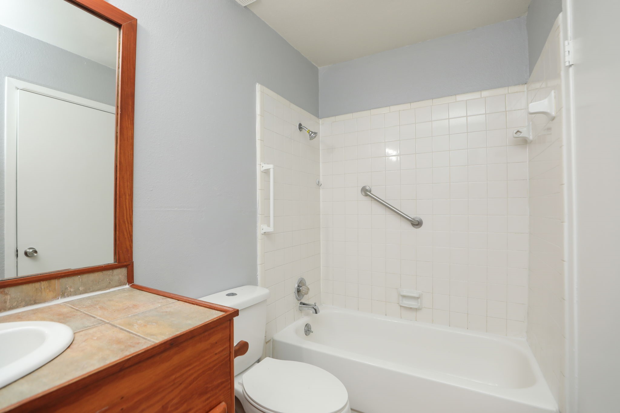 2100 Wilcrest Drive, Unit 127 Houston, TX 77077 - Photo 30 of 38 a bathroom with a granite countertop sink toilet and shower