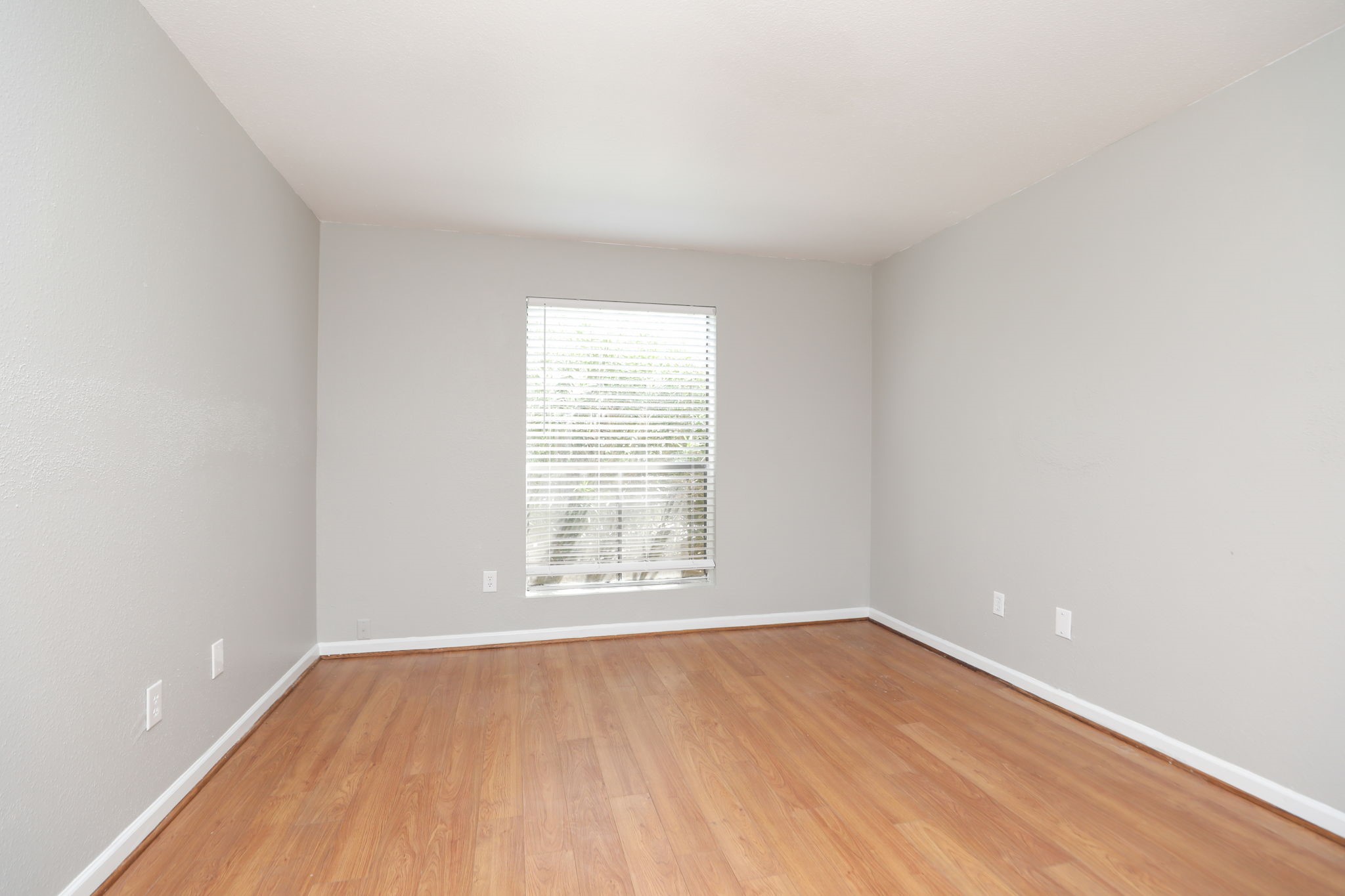 2100 Wilcrest Drive, Unit 127 Houston, TX 77077 - Photo 31 of 38 an empty room with wooden floor and windows