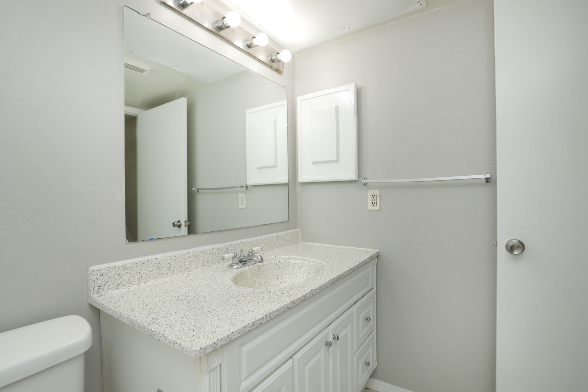 2100 Wilcrest Drive, Unit 127 Houston, TX 77077 - Photo 33 of 38 a bathroom with a sink a toilet and a mirror