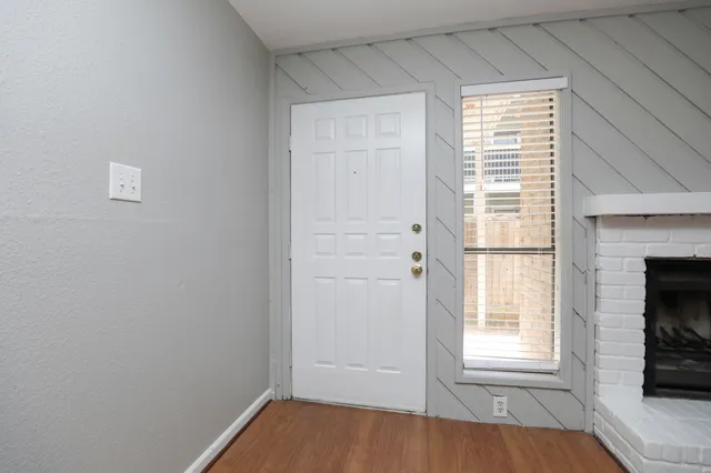 an empty room with a fireplace and window