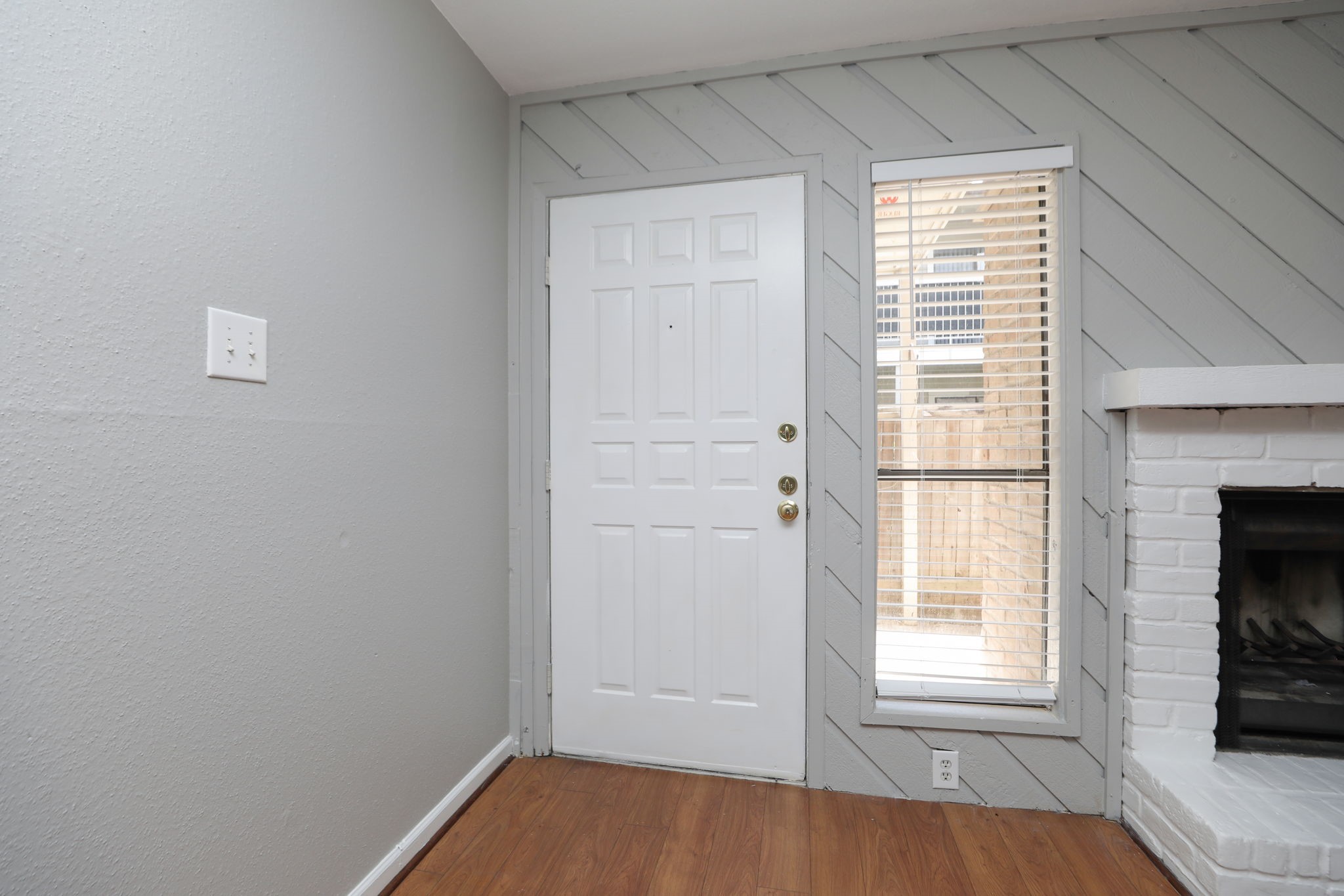 2100 Wilcrest Drive, Unit 127 Houston, TX 77077 - Photo 9 of 38 an empty room with wooden floor fireplace and windows