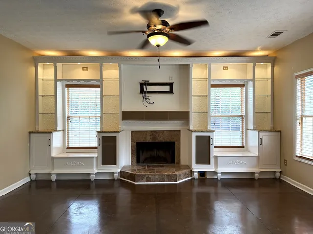 a living room with a fireplace and wooden floor