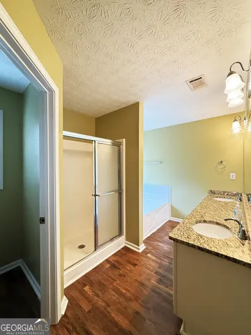 a bathroom with a granite countertop sink and a mirror