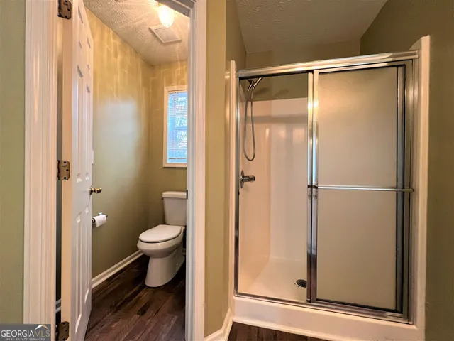 a bathroom that has a glass shower door