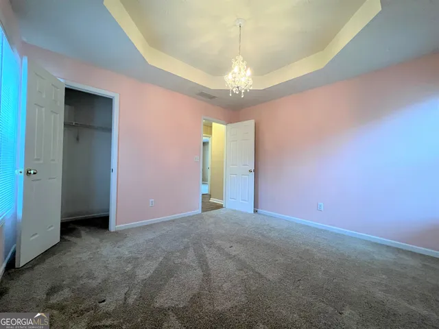 an empty room with a chandelier and a chandelier