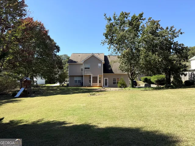 a view of a house with a yard covered with snow