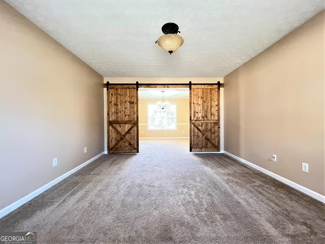 an empty room with windows and closet