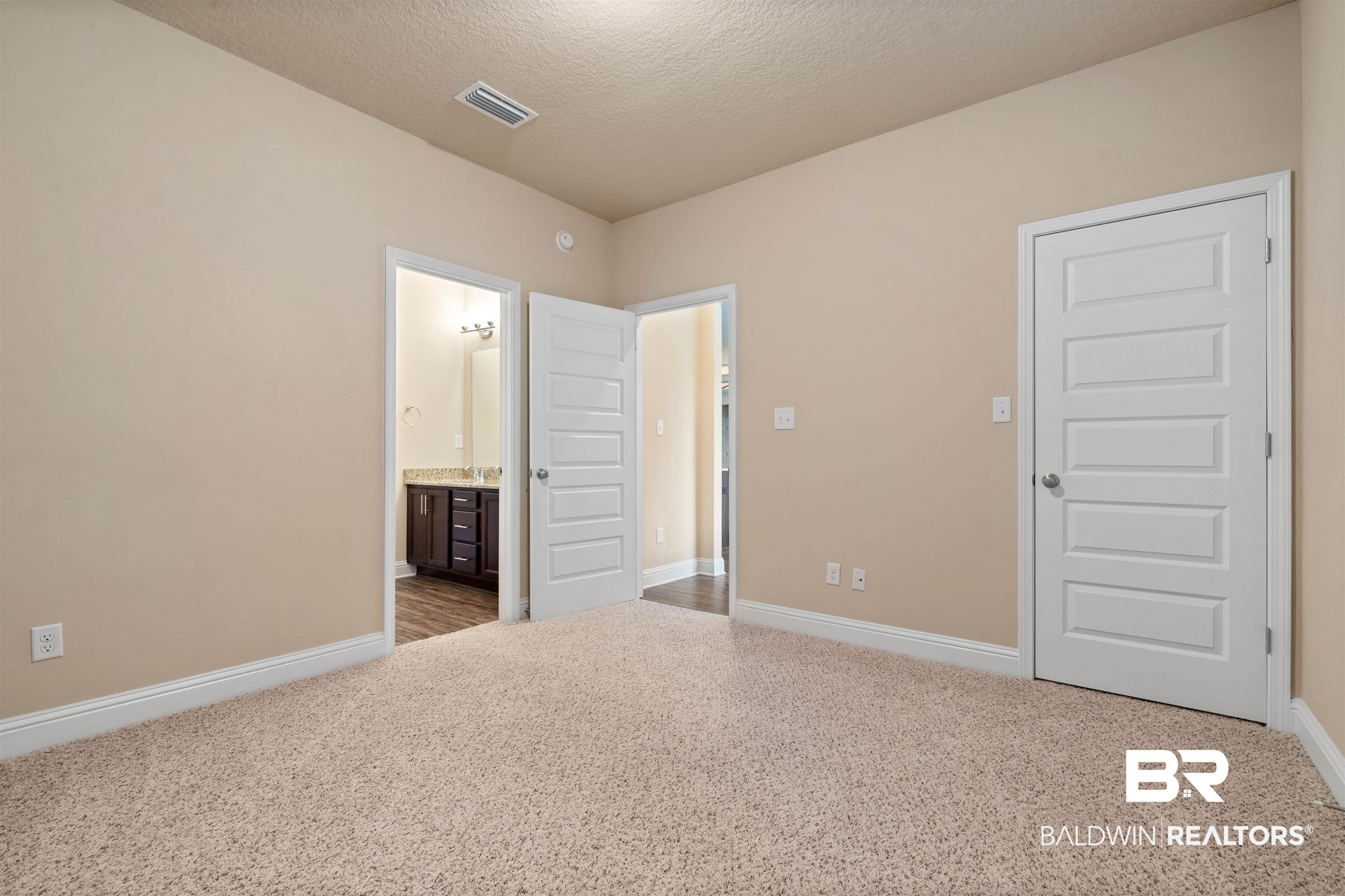 1864 Gwin Court Mobile, AL 36695 - Photo 29 of 37 Unfurnished bedroom with a textured ceiling, light carpet, and ensuite bathroom